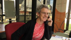 volunteer on the phone in the Resource Centre