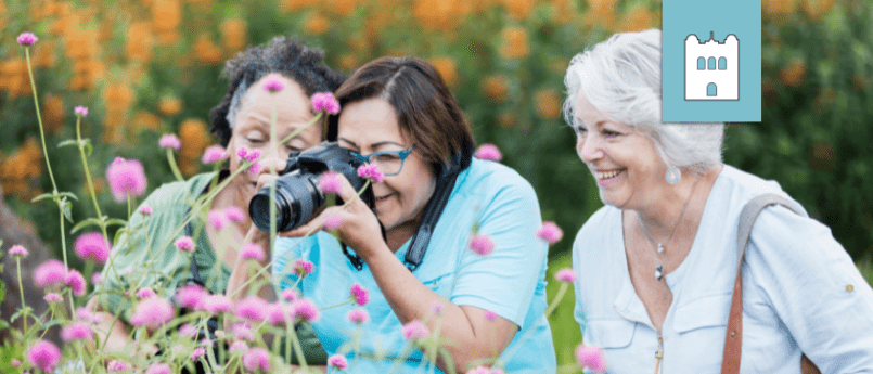 women photographing flowers