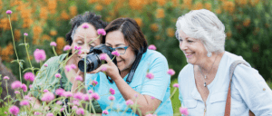 women taking photos of flowers