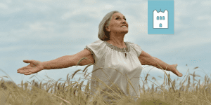 woman with open arms in field