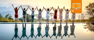 group of women with hands in the air looking out to the mountains