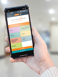 Phone in a woman's hand showing the Counterpart Navigator homepage