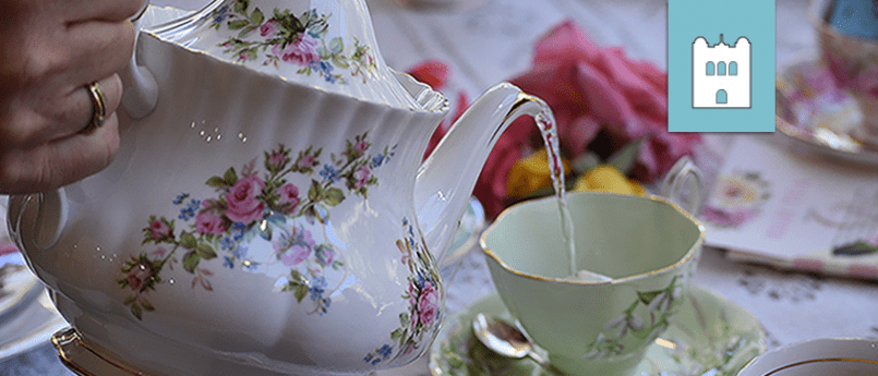tea pot pouring tea into cup