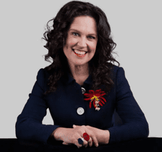 Portrait of Annabelle Crabb, journalist and writer, against a plain white background.