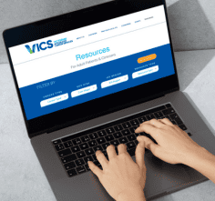 VICS website mocked up on laptop