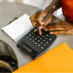 woman typing into calculator