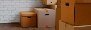 boxes stacked in front of white brick wall