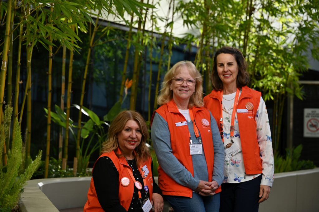 Mary Macheras Magias, Bridge Of Support Coordinator with Peer Support Volunteers Rosanne and Emma outside Peter Mac.
